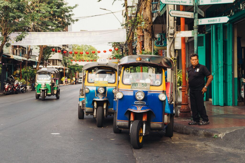 Iconic tuk tuks parked on a bustling street in phnom penh, Cambodia