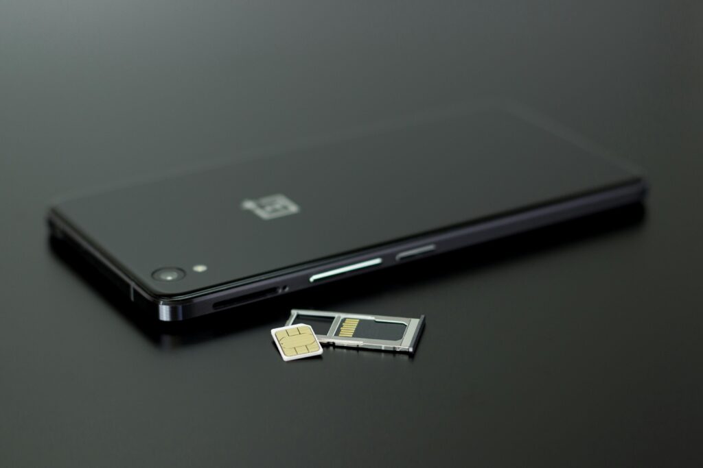 Close-up of a smartphone with a SIM card and memory card, showcasing modern technology.