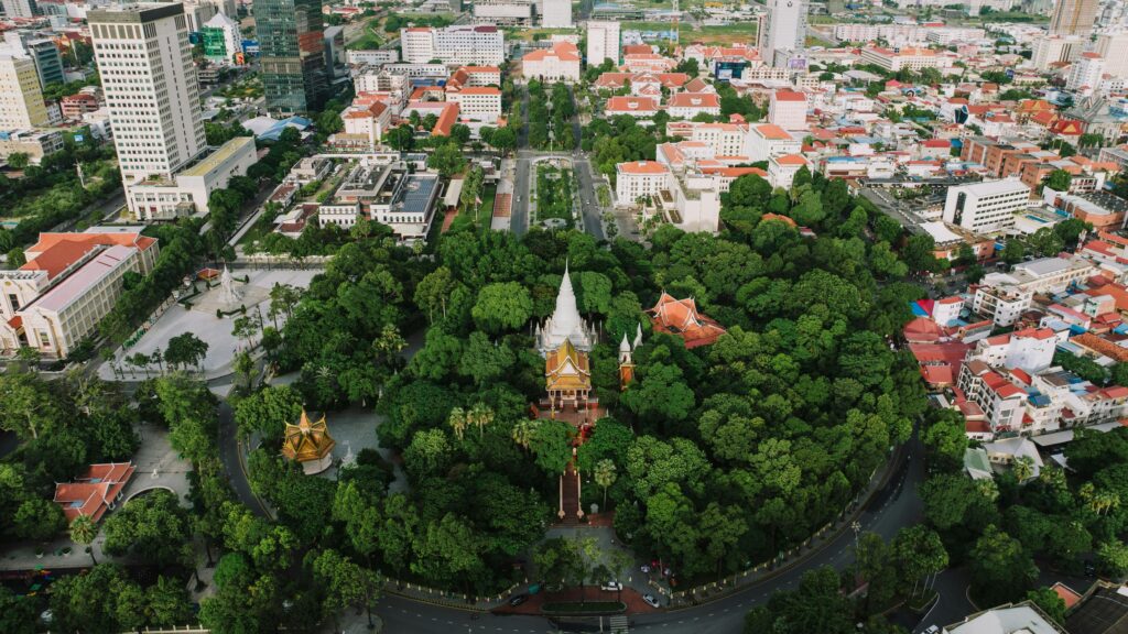 Drone shot of Wat Phnom surrounded by urban landscape in Phnom Penh, Cambodia.