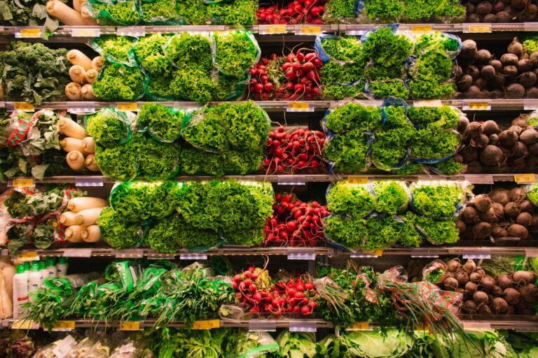 Colorful assortment of fresh vegetables arranged on supermarket shelves, perfect for healthy eating themes.