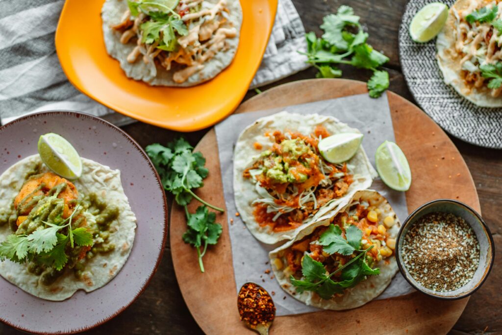 Delicious Mexican tacos with fresh cilantro, lime and toppings, perfect for food photography.